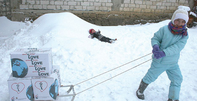 Children in Eastern Europe having fun in the snow as they receive their Operation Christmas Love parcels.