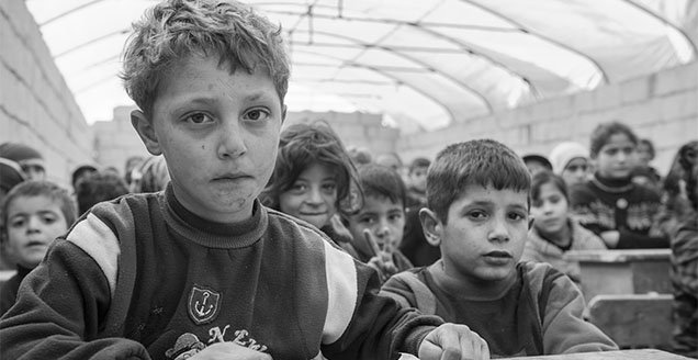 School children in a makeshift class at a camp for displaced Syrians.