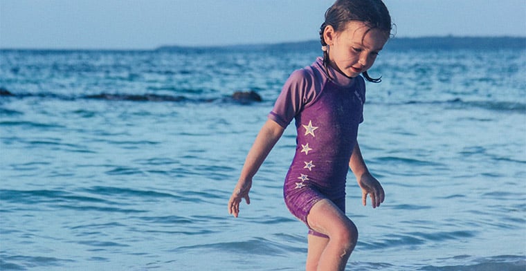 Young girl playing at the beach