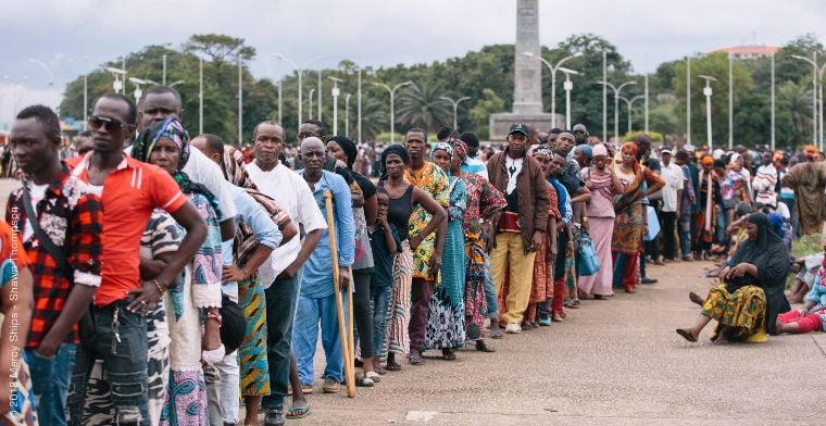 Patients lined up waiting to be assessed by Mercy Ships