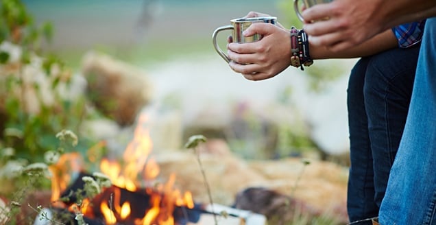 Guy and girl by campfire