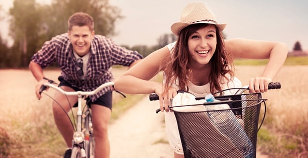 Guy and girl riding bikes