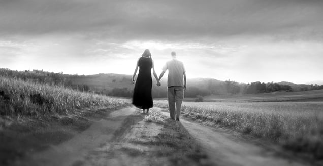 Couple walking down a path into the Into distance