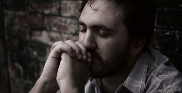 Man eyes closed in prayer