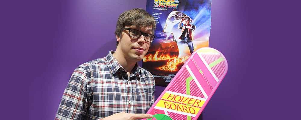 Hope 103.2 presenter Sam Robinson with Hoverboard and Back To The Future poster