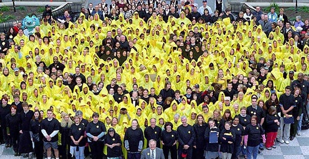 People form a giant smiley logo
