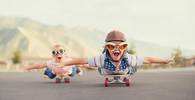 Kids having a fun skateboard 'flying' experience
