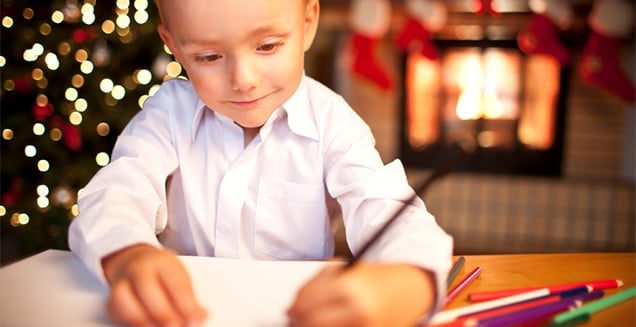 Little boy writing a letter at Christmas time