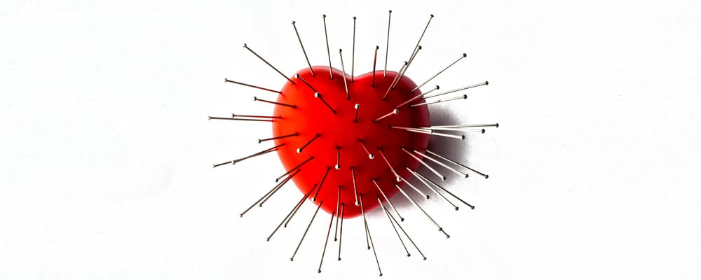 Red heart full of pins