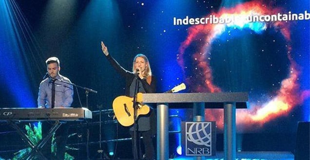 Laura Story leads worship at a conference