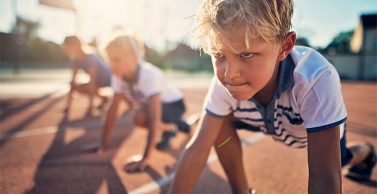 Boy on running track at start of race