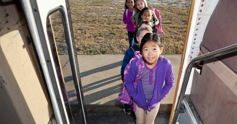 Children in line to board school bus