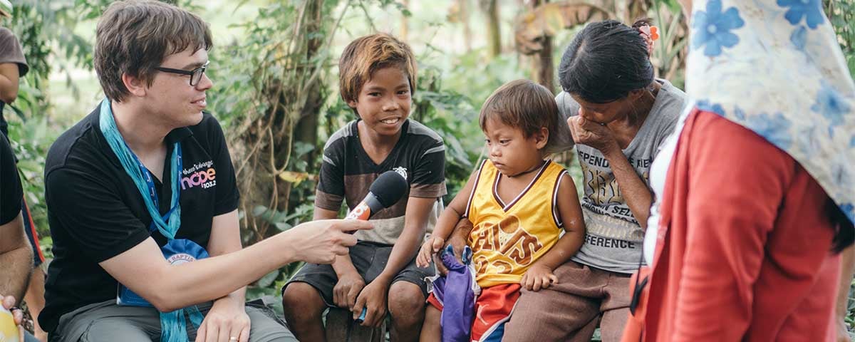 Sam Robinson with a sponsor child in the Philippines