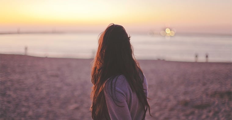 Woman at beach at sunrise