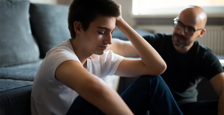 Teen son listening to a father's advice