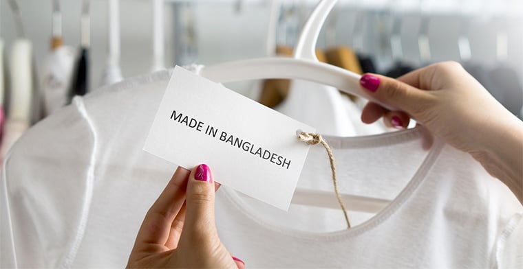 Woman holding T-shirt made in Bangladesh