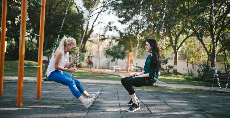 Two girls on swings