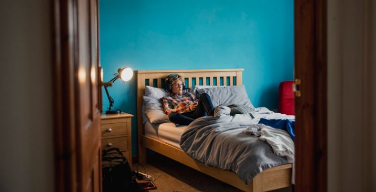 Boy gaming in his bedroom