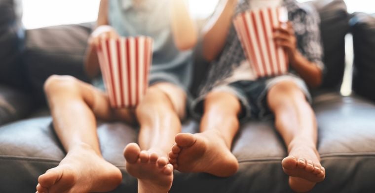 Kids watching movie on couch