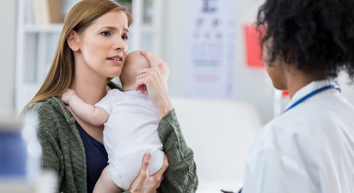 Anxious mum and baby with doctor