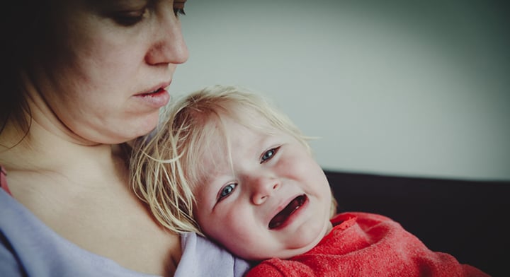 Mother comforting crying toddler