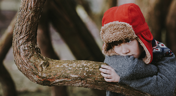Bored child on a tree