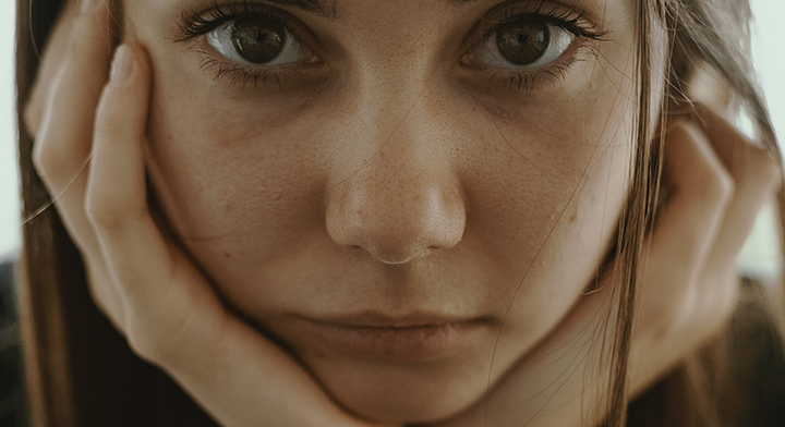 Bored girl with hands on face
