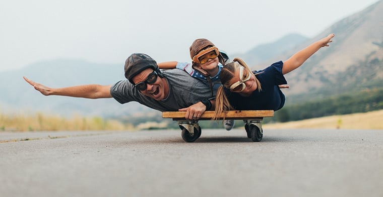 Young Kids and Dad Flying on a Press Cart