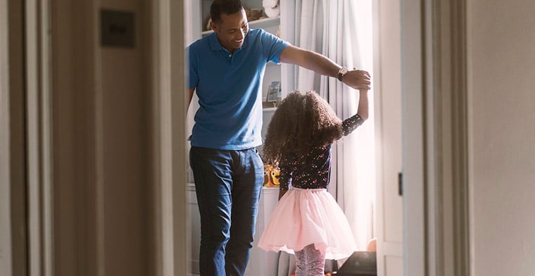 Dad dancing with daughter