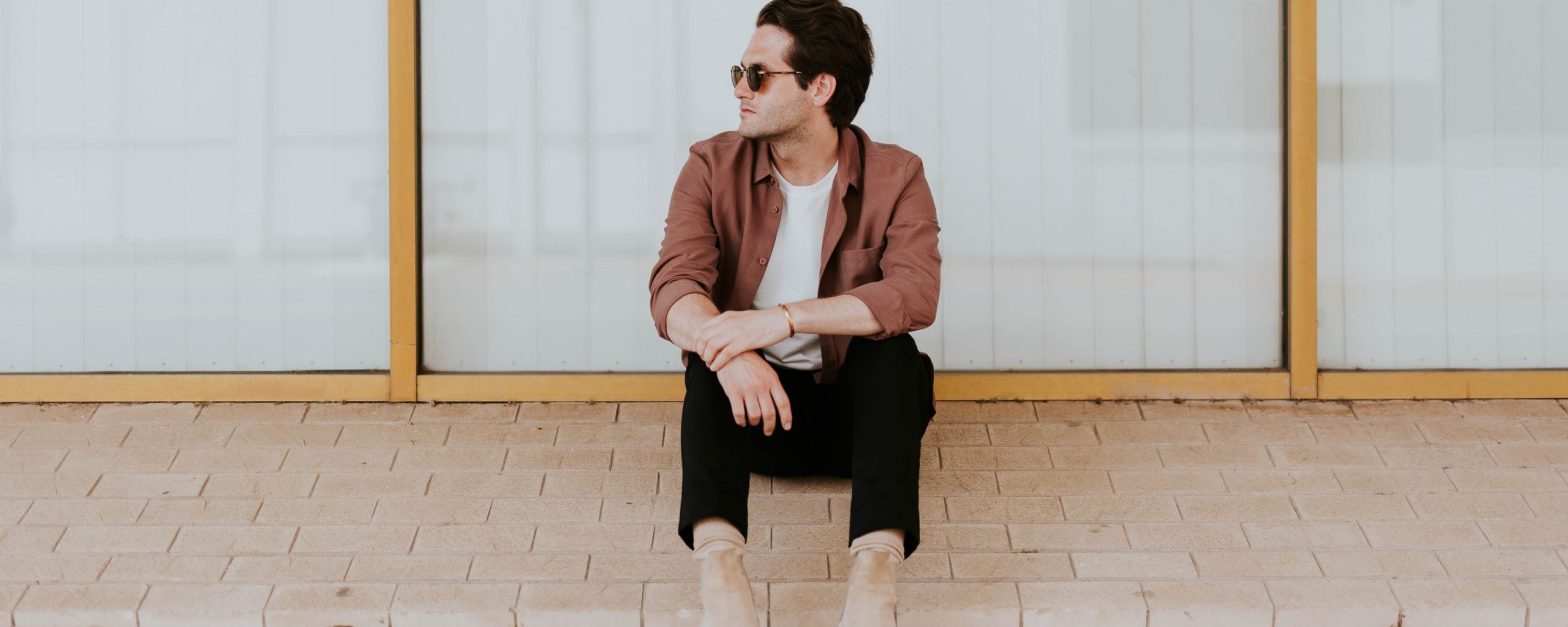 Man waiting on sidewalk -