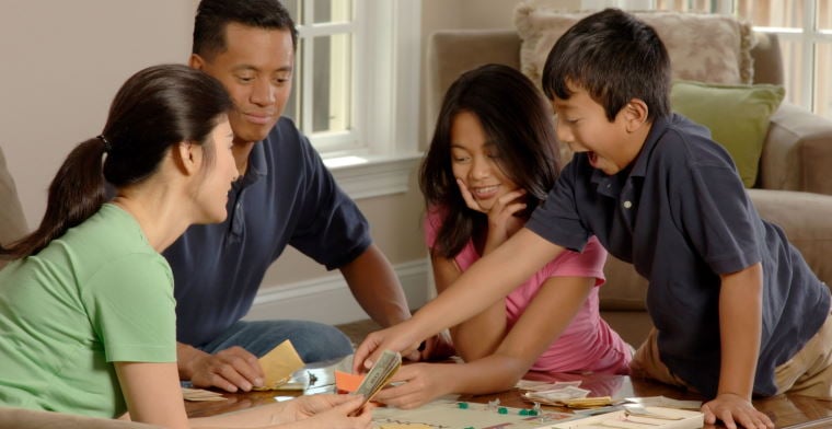Family playing Monopoly
