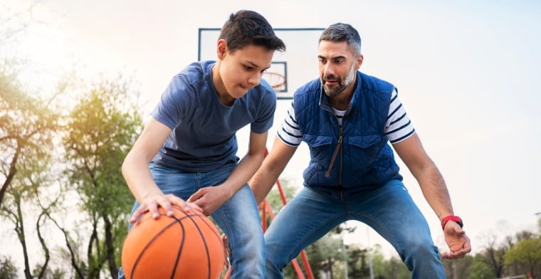 Father and son playing basketball