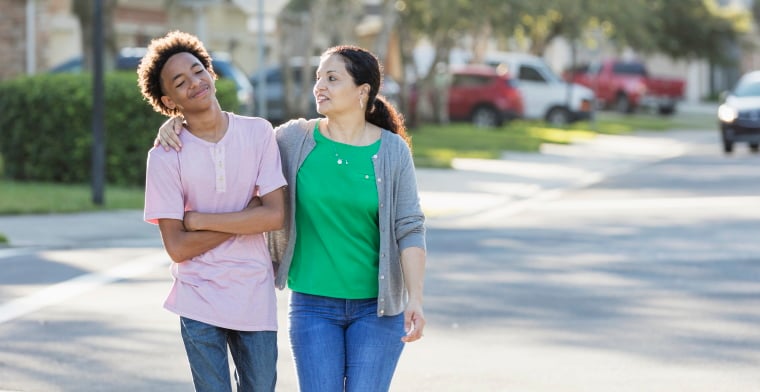 Mum and son walking on street