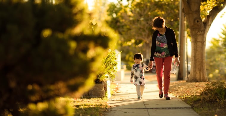 Woman walking with little daughter
