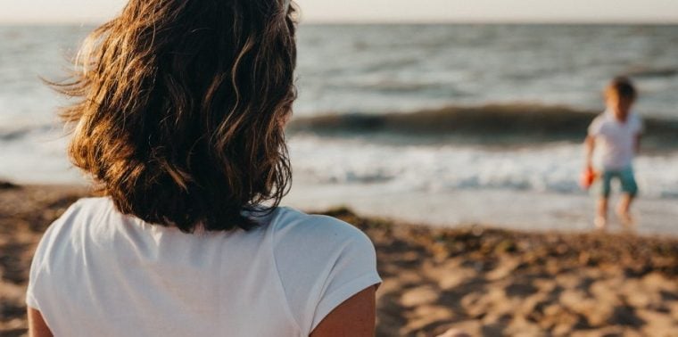Woman on beach with kid