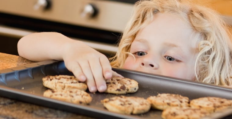 Sneaky boy stealing cookie