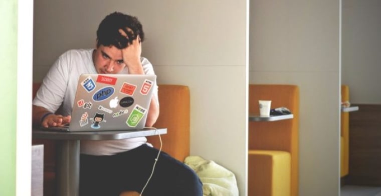 Guy with laptop tired