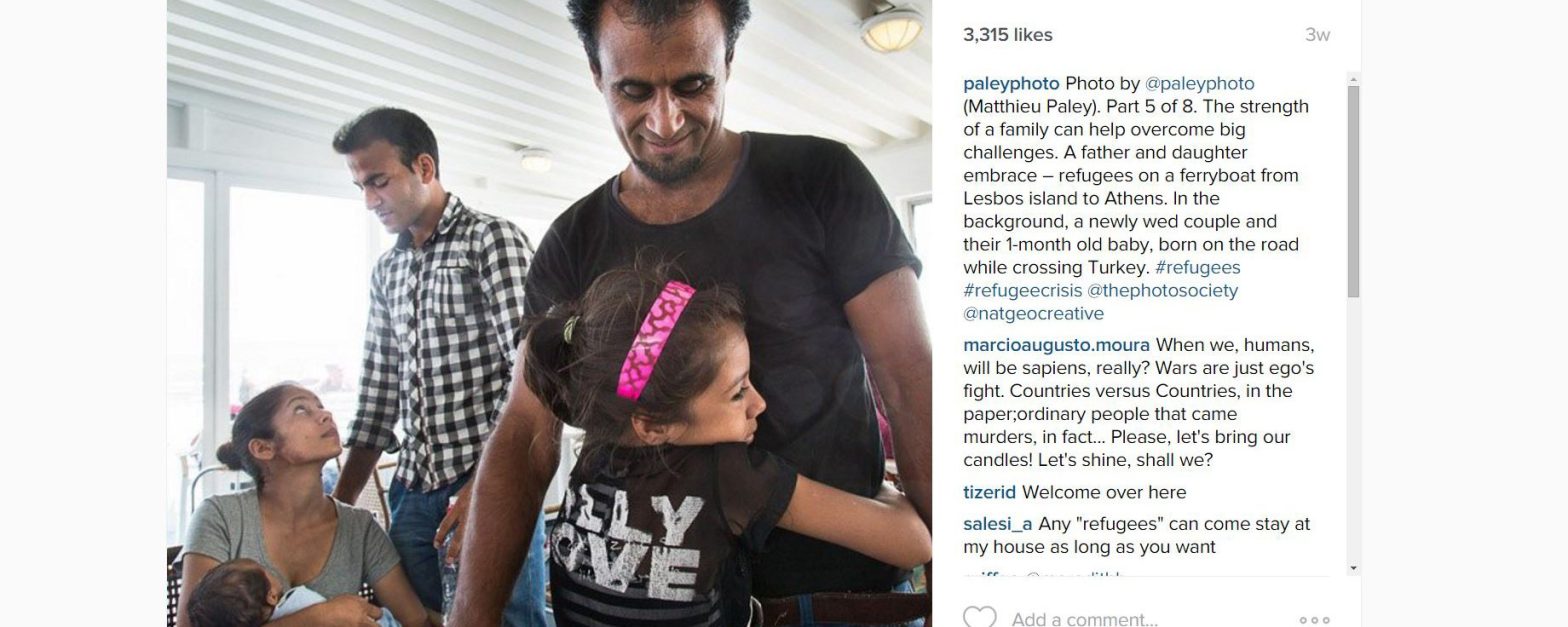 Refugee father and daughter hug on a ferry from Turkey to