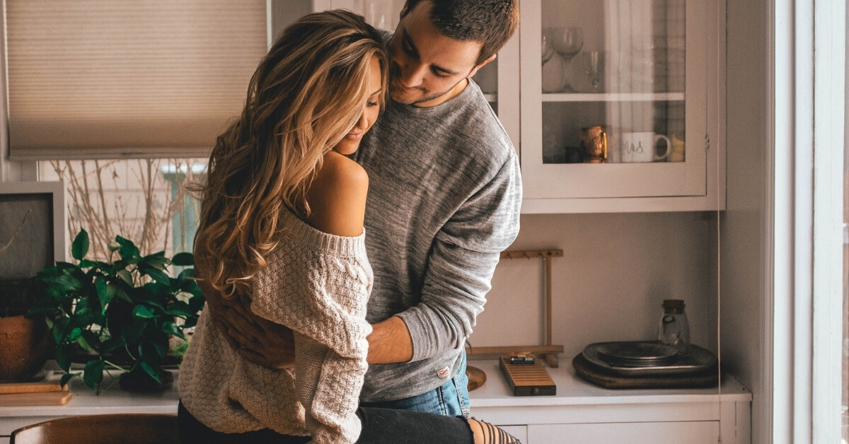 couple hugging in the kitchen