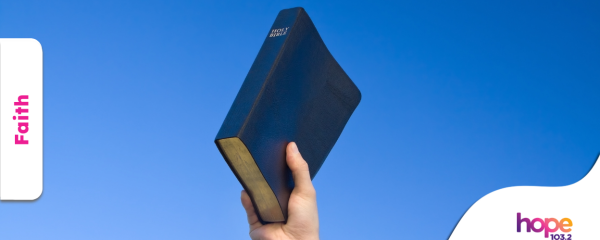 Hand holding Bible to the sky, image by CanvaPro