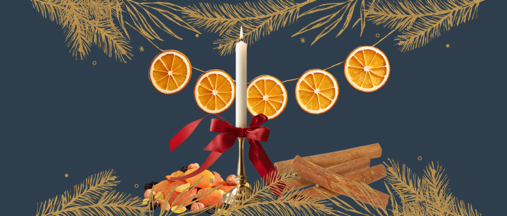White candle, red ribbon, dried oranges, dried fruit, cinnamon sticks photo by CanvaPro